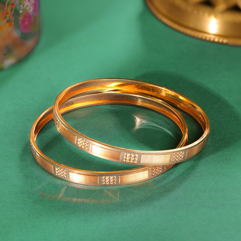 

Modish Yellow Gold Carved Bangles